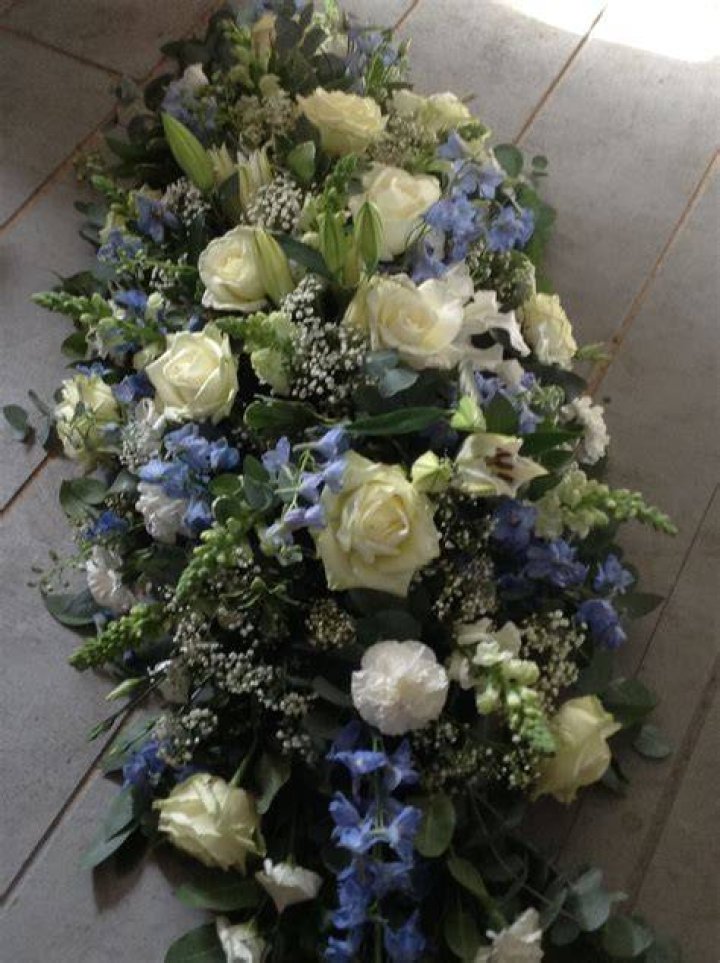 What do blue flowers mean at a funeral?